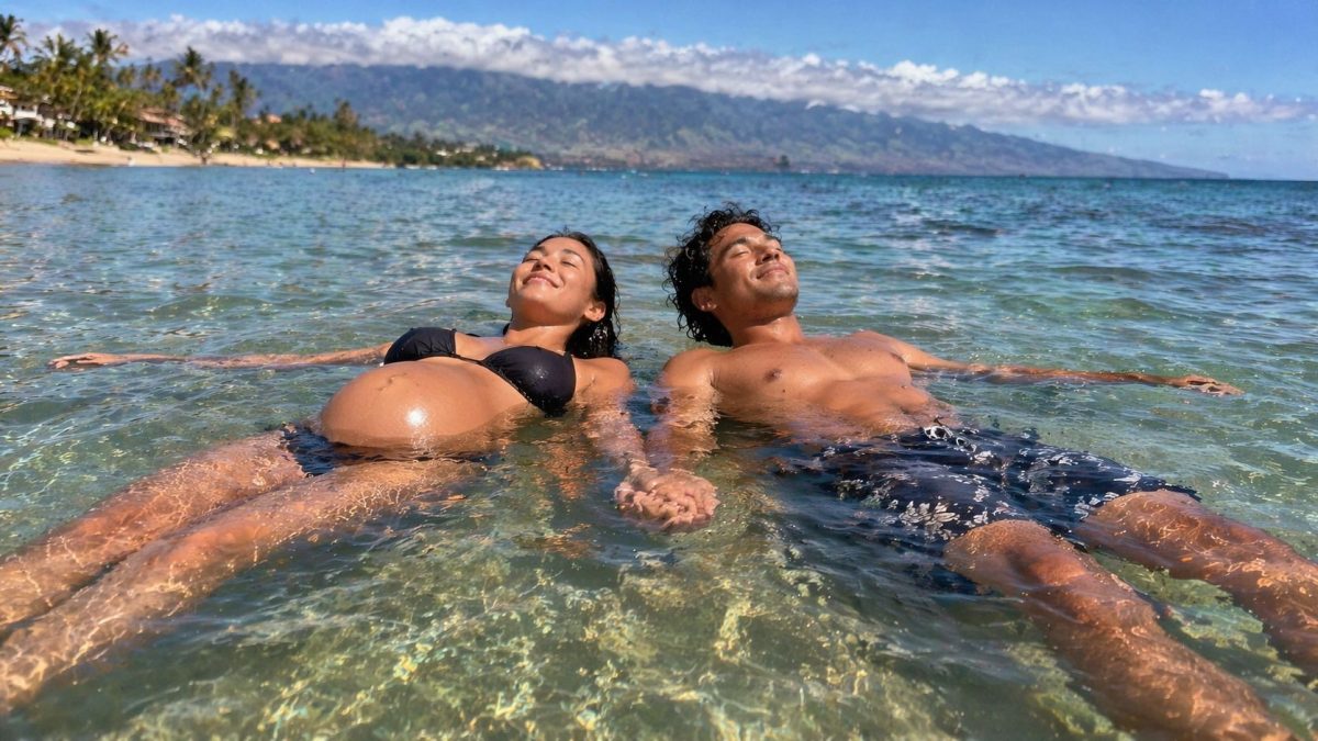Expecting couple floating in shallow calm water at Kamaole Beach in Kihei
