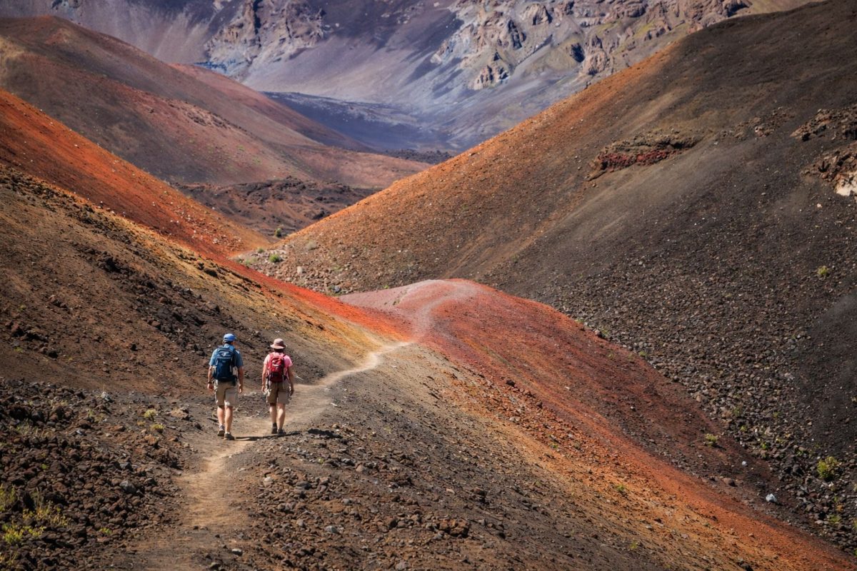 Hikers at Sliding Sands Trail entrance Haleakala showing vast crater landscape